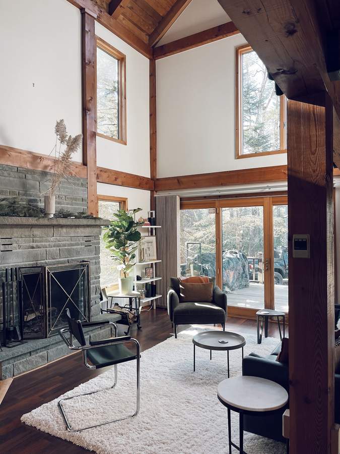 Sunlit living room with vaulted wood ceiling at Lofty Cabin