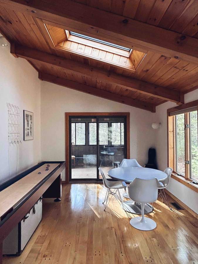 Game room with shuffleboard table at Lofty Cabin