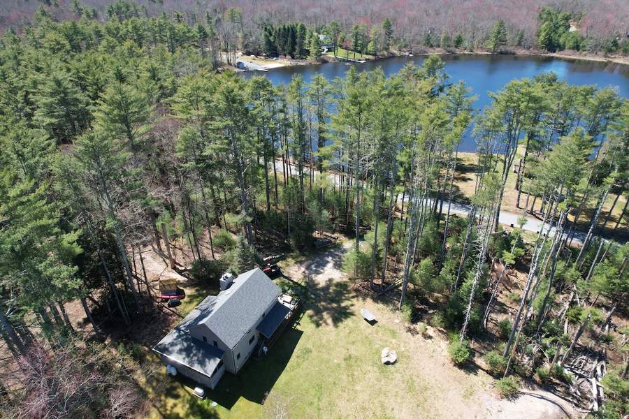Black exterior of Lofty Cabin with forest-facing deck